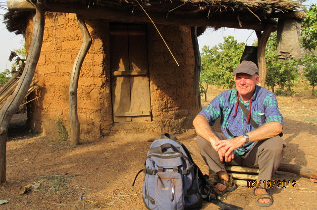 John taking a rest by Mr. Mama Djilla's hut in his field. No one used the land because everyone thought the devil lived there, but Mr. Djilla, who had been away from Koura for years, decided as a Christian he could use it, and now everyone wants to farm the area. 

